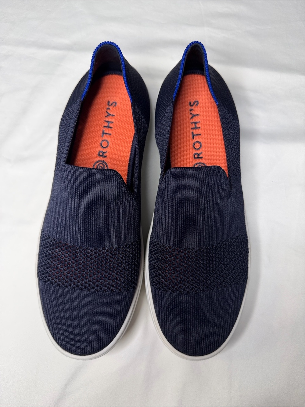 Rothy's Navy Knit Slip-On Sneakers with Orange Insole